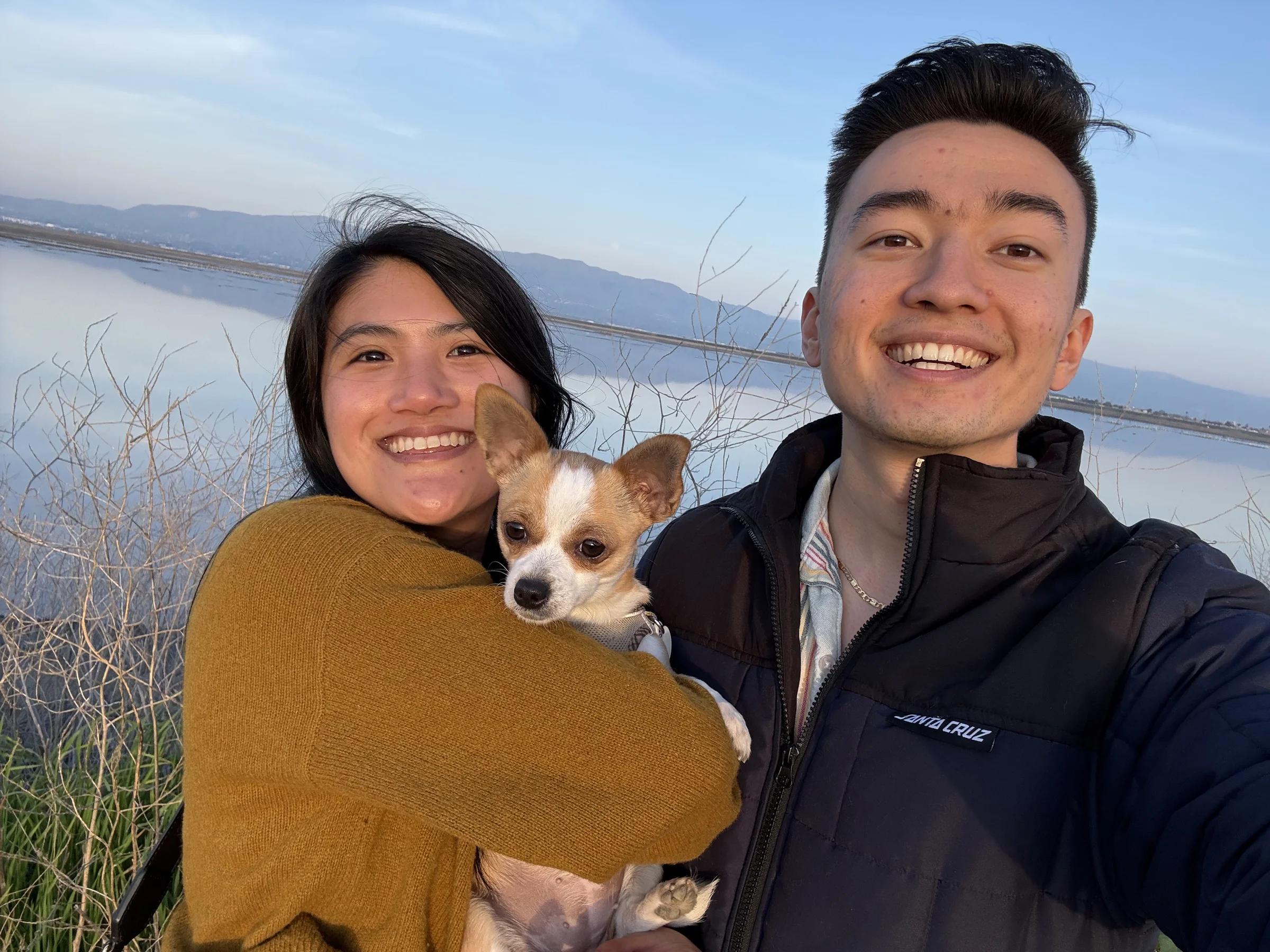 Olivia, Geoff, and Biscuit at the Bay at sunset
