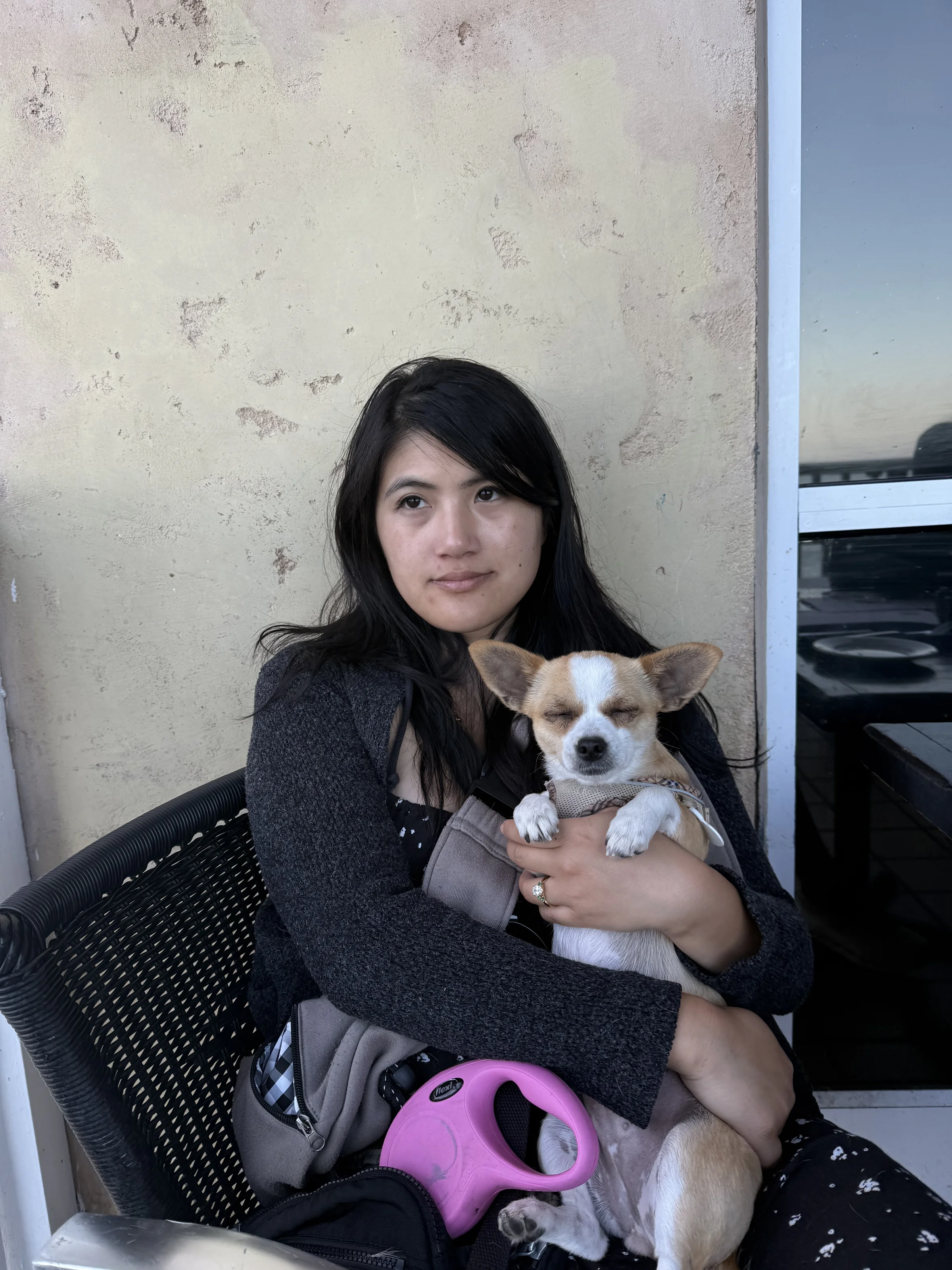 Olivia holding a sleepy Biscuit the Chihuahua